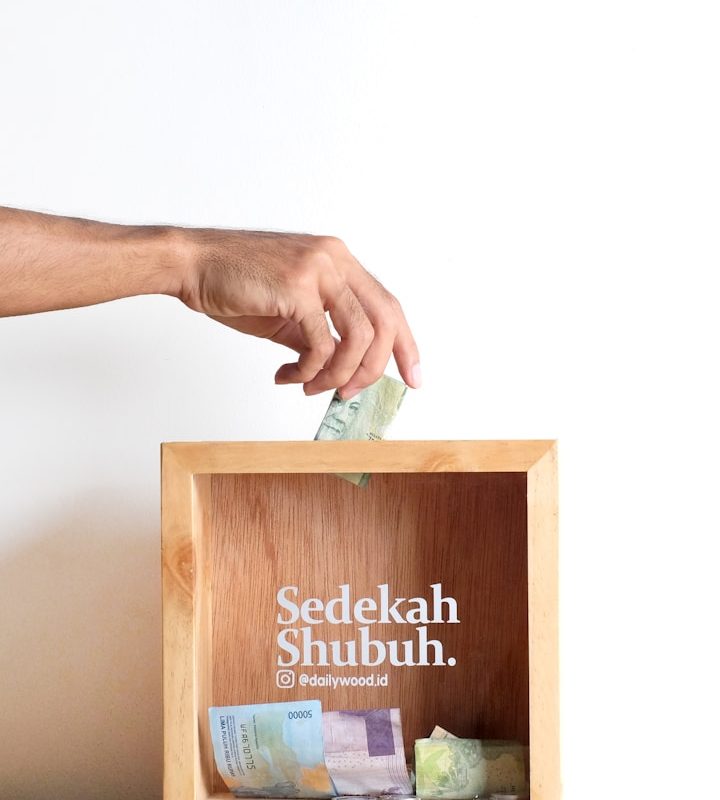 person holding brown wooden box